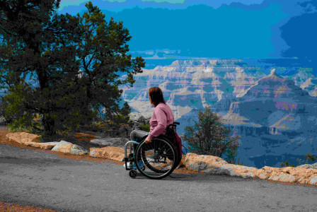 An illustrative photo of a woman in a wheel chair on a cliff.