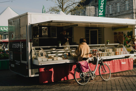 Photo by Unsplash An illustrative photo of a woman buying something in a small shop.