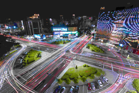 An illustrative photo of a city street filled with lots of traffic at night.