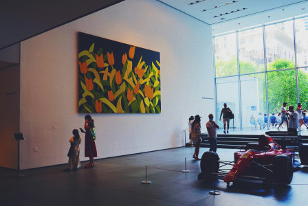Photo by Unsplash An illustrative photo of a group of people standing in front of a painting.