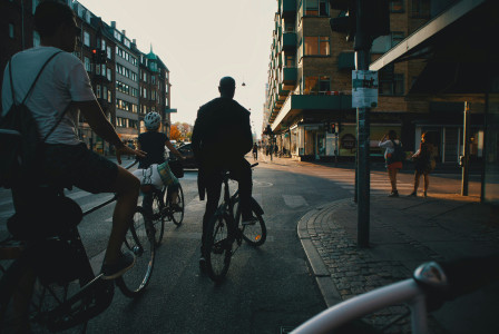 An illustrative photo of people riding bicycles on a road.