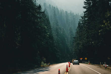 An illustrative photo of a car driving down a road.