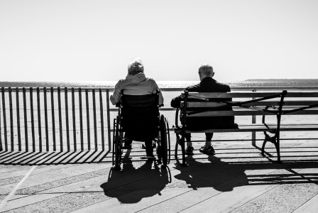 An illustrative photo of a couple sitting on the bench.