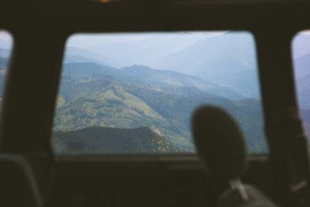 An illustrative photo of a view of mountains from inside a vehicle.
