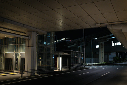 An illustrative photo of an empty city street at night with a building.