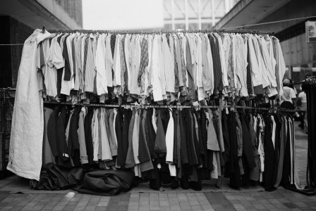 Black and white photograph of clothes hanging on a clothes line.