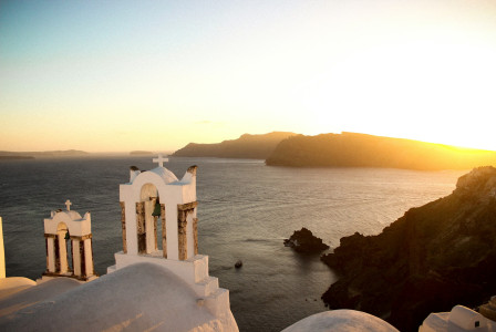white-concrete-building-on-top-of-mountain-near-body-of-water-during-daytime