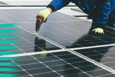 Worker installing solar panels