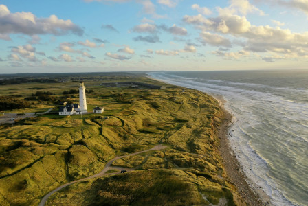 Photo by Unsplash A white lighthouse on the North Sea coast