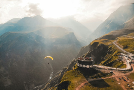 Photo by Unsplash Person paragliding on the mountain cliff