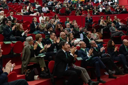 Group of people applauding at a conference. 