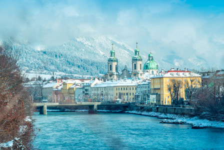 View of buildings in the snow over a river