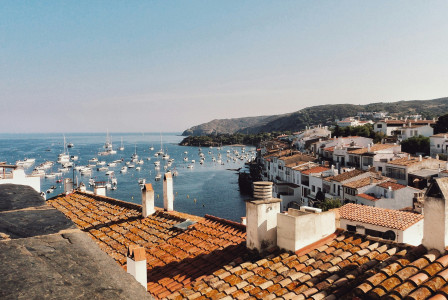 A town overlooking a marine with yachts