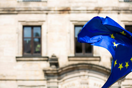 EU flag with a stone building in the background