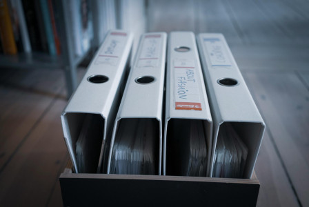 Collection of ring binders inside a box. 