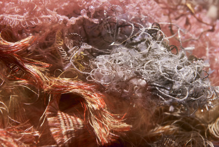 macro shot of tangled, colorful fibers and threads