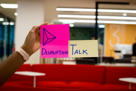 Sticky note with the words "disruption talk"
