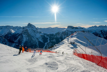 a-group-of-people-riding-skis-on-top-of-a-snow-covered-slope