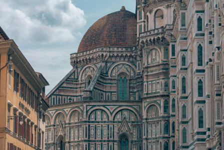 -tall-building-with-a-clock-on-the-front-of-it