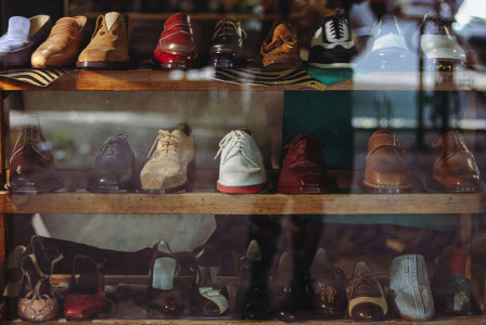 A display case filled with lots of different types of shoes. 