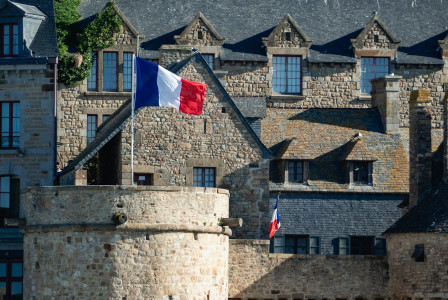 french-flag-waves-proudly-over-the-stone-buildings