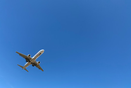 a-large-jetliner-flying-through-a-blue-sky