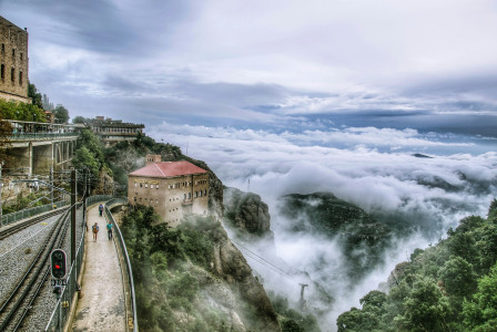 a-train-track-with-a-building-on-it-and-trees-around-it