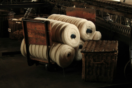 several rolls of yarn on a wooden chair