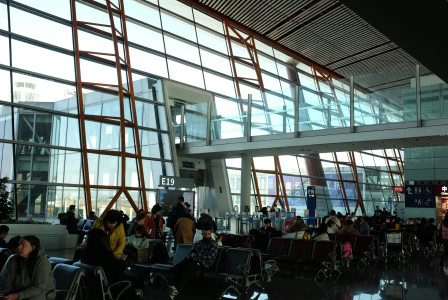 people-waiting-in-a-modern-airport-terminal-with-large-windows