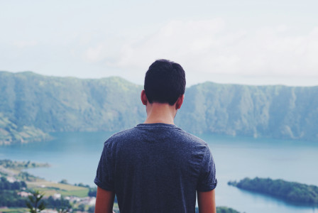man-standing-outdoors-with-body-of-water-at-distance-during-daytime