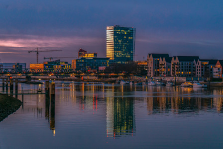 a-body-of-water-with-a-city-in-the-background
