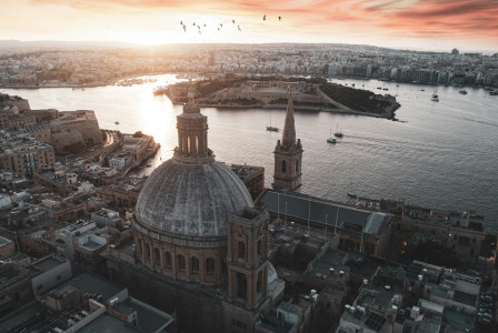 brown-and-white-dome-building-near-body-of-water-during-daytime