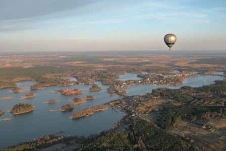 -hot-air-balloon-flying-over-a-large-body-of-water