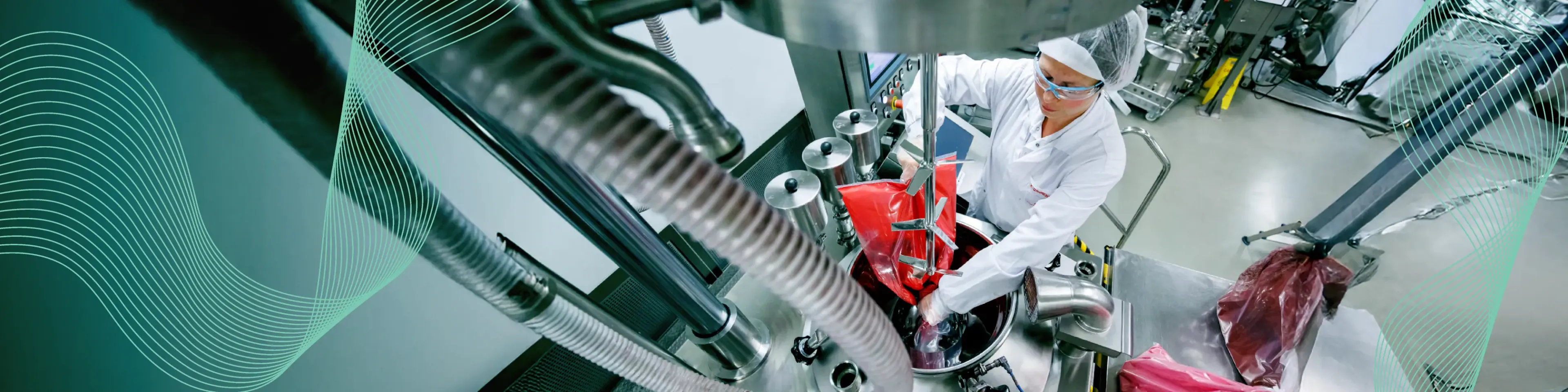 Scientist operating industrial mixing equipment in a lab.
