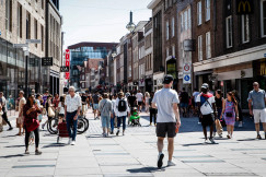 people walking between buildings