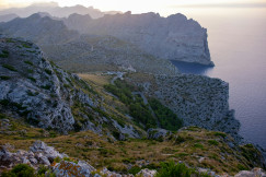 a-view-of-a-mountain-with-a-body-of-water-in-the-distance