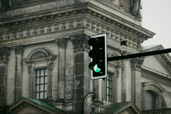a-traffic-light-is-green-in-front-of-a-building