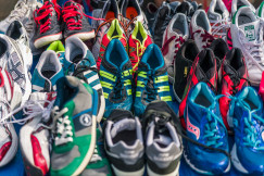 Colour photograph of a batch of assorted trainers, by Atanas Dzhingarov on unsplash.