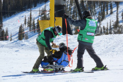 man-in-green-jacket-and-black-pants-standing-on-snow-covered-ground-during-daytime