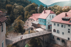 three-white-and-blue-concrete-house-near-brown-bridge