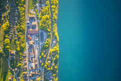 aerial-view-of-a-town-along-a-bright-blue-lake