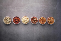 Assorted nuts in small bowls.
