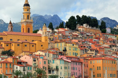 colorful-buildings-on-a-hillside-with-mountains-behind