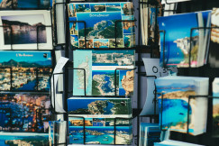 selective-focus-photography-of-landmarks-card-on-rack-