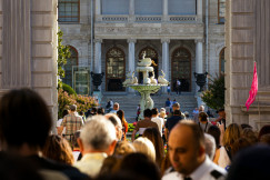 a-crowd-of-people-standing-in-front-of-a-building