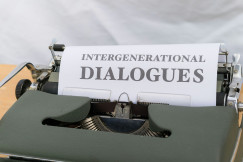 Colour photograph of the black text “intergenerational dialogues” on a white piece of paper on a typewriter. Markus Winkler on unsplash.
