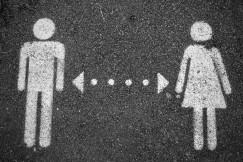 Colour photograph of a female and male symbol connected by a bi-directional arrow. Pea on unsplash.