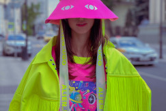 A person wearing brightly coloured contemporary fashion pieces stands outdoors, illustrating creativity, design and innovative approaches to fashion showcased at Green Fashion Week Milano 2026.