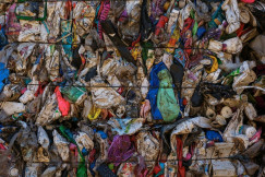 Compressed bale of dirty mixed plastic waste and containers.