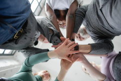 5 people doing a hand stack